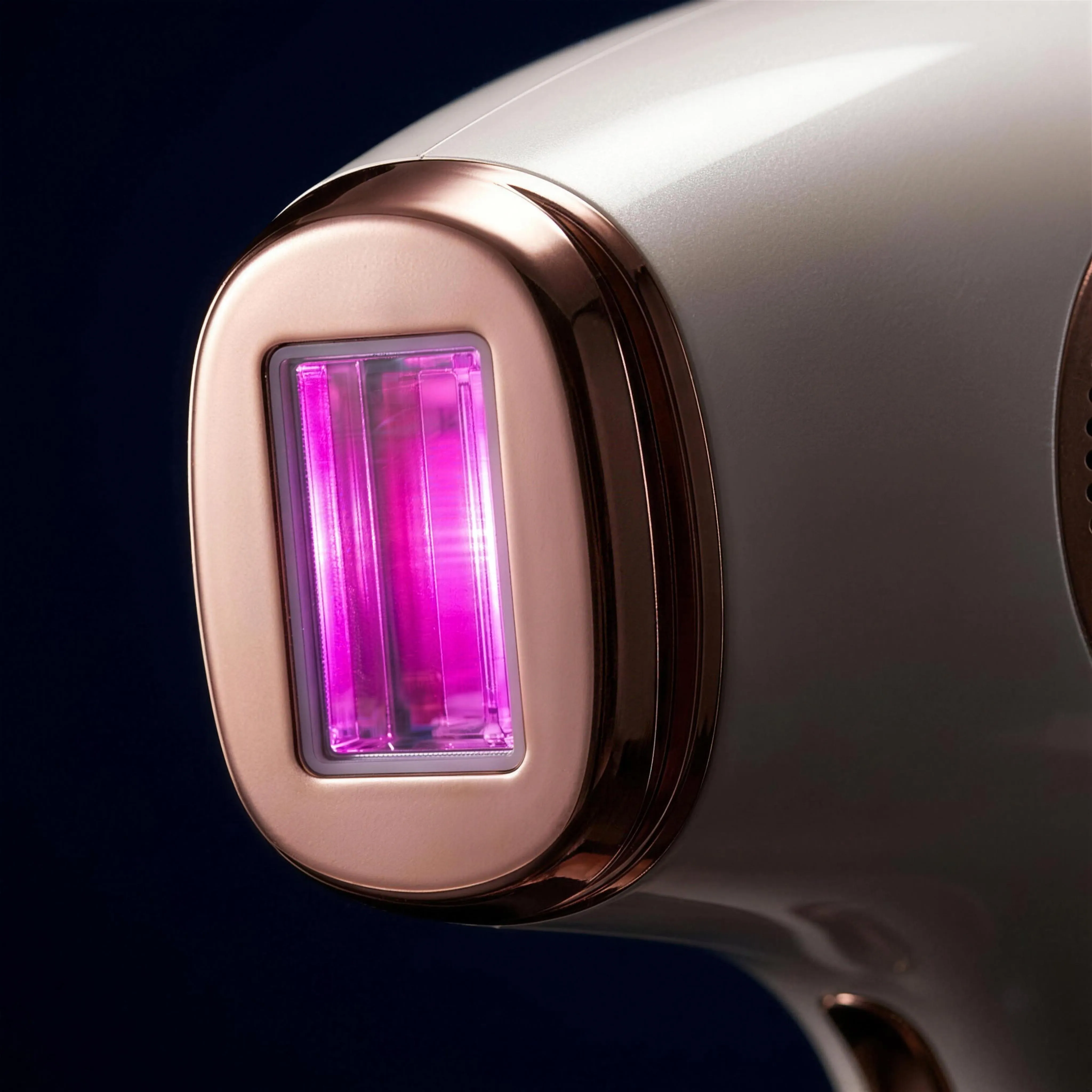 Macro detail of the rose-gold flash window glowing magenta